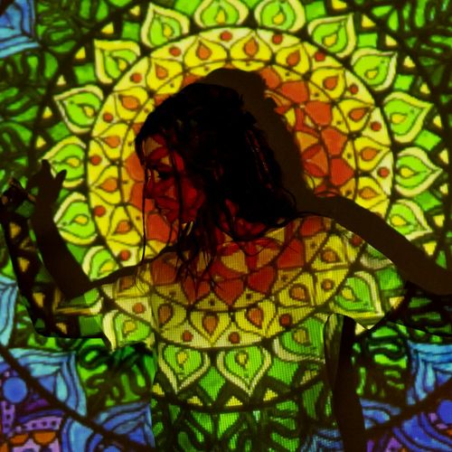 Symbol of mind and body connection, possibly a lotus or abstract shape.